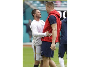 Miami Dolphins wide receiver Danny Amendola, left, greets New England Patriots tight end Rob Gronkowski, before an NFL football game, Sunday, Dec. 9, 2018, in Miami Gardens, Fla.