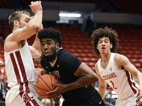 Idaho guard Marquell Fraser (15) drives to the basket as Washington State forward Jeff Pollard (13) and forward CJ Elleby (2) defend during the first half of an NCAA college Basketball game, Wednesday, Dec. 5, 2018, in Pullman, Wash.