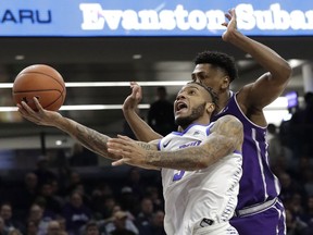 DePaul guard Devin Gage, left, drives to the basket past Northwestern guard Anthony Gaines during the first half of an NCAA college basketball game Saturday, Dec. 8, 2018, in Evanston, Ill.