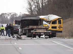 Indiana State Police investigate a collision between an East Pulaski school bus and truck on Wednesday, Dec. 5, 2018, in Argos, Ind. Police say one student was killed and another was injured when a flatbed truck collided with a school bus.