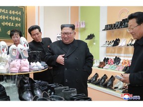 In this undated photo released Monday, Dec. 3, 2018, by the North Korean government, North Korean leader Kim Jong Un, center, visits the Wonsan Shoes Factory in Gangwon, North Korea. South Korea's President Moon Jae-in says U.S. President Donald Trump told him he has a "very friendly view" of North Korean leader Kim Jong Un and wants to grant his wishes if he denuclearizes. Independent journalists were not given access to cover the event depicted in this image distributed by the North Korean government. The content of this image is as provided and cannot be independently verified. Korean language watermark on image as provided by source reads: "KCNA" which is the abbreviation for Korean Central News Agency. (Korean Central News Agency/Korea News Service via AP)