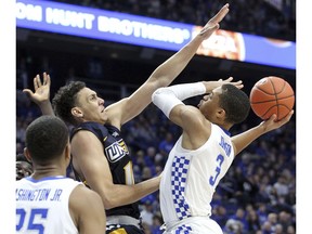 Kentucky's Keldon Johnson (3) shoots while pressured by UNC Greensboro's Kyrin Galloway during the first half of an NCAA college basketball game in Lexington, Ky., Saturday, Dec. 1, 2018.