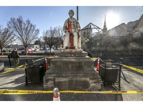 In this Dec. 10, 2018 photo, the George Dennison Prentice statue sits in front of the main branch of the Louisville Free Public Library after it was dislodged from its base in Louisville, Ky. The statue of the Kentucky newspaper editor whose anti-immigration and anti-Catholic editorials were blamed for a deadly Election Day riot in 1855 is being moved to a storage facility on Tuesday, Dec. 11.