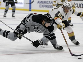 Los Angeles Kings right wing Dustin Brown, left, battles Vegas Golden Knights center Cody Eakin for the puck during the second period of an NHL hockey game in Los Angeles, Saturday, Dec. 8, 2018.