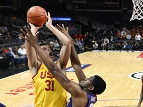 Southern California forward Nick Rakocevic, left, shoots as TCU center Kevin Samuel defends during the first half of an NCAA college basketball game at the Basketball Hall of Fame Classic on Friday, Dec. 7, 2018, in Los Angeles.