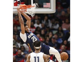 New Orleans Pelicans forward Anthony Davis (23) scores a basket against the Memphis Grizzlies in the first half of an NBA basketball game in New Orleans, Friday, Dec. 7, 2018.
