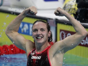FILE - In this Sunday, July 30, 2017 file photo, Hungary's Katinka Hosszu celebrates after winning the gold medal in the women's 400-meter individual medley final during the swimming competitions of the World Aquatics Championships in Budapest, Hungary. Three Olympic and world champion swimmers have filed an anti-trust suit in California challenging governing body FINA's control of organizing competitions, it was announced Saturday, Dec. 8, 2018. The legal action by Hungarian great Katinka Hosszu and Americans Tom Shields and Michael Andrew follows Switzerland-based FINA shutting down an independent meet in Italy with threats to ban competitors.