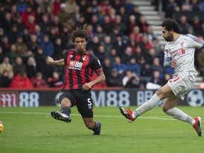 Liverpool's Mohamed Salah, right, scores his side's second goal of the game during their English Premier League soccer match against Bournemouth at the Vitality Stadium, Bournemouth, England, Saturday, Dec. 8, 2018.