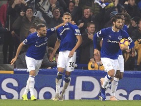 Everton's Richarlison, centre, celebrates scoring his side's first goal of the game against Newcastle United during their English Premier League soccer match at Goodison Park in Liverpool, Wednesday Dec. 5, 2018.
