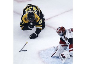 Boston Bruins right wing David Backes (42) falls to the ice after taking a skate to the face during the first period of hockey game against the Arizona Coyotes in Boston, Tuesday, Dec. 11, 2018. At right is Arizona Coyotes goaltender Darcy Kuemper.