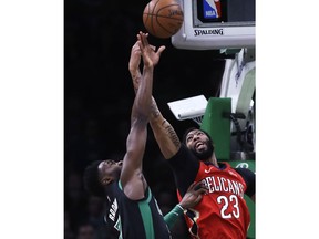 New Orleans Pelicans forward Anthony Davis (23) and Boston Celtics guard Jaylen Brown (7) battle for a rebound during the first quarter of a basketball game in Boston, Monday, Dec. 10, 2018.