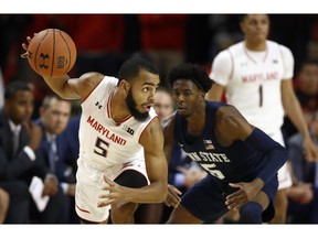 Maryland guard Eric Ayala, left, protects the ball from Penn State guard Jamari Wheeler in the first half of an NCAA college basketball game, Saturday, Dec. 1, 2018, in College Park, Md.