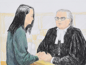 In this courtroom sketch, Meng Wanzhou the chief financial officer of Huawei Technologies speaks to her lawyer David Martin during a bail hearing at B.C. Supreme Court in Vancouver, Dec. 10, 2018.