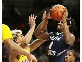 North Florida forward Wajid Aminu (2) shoots against Minnesota forward Jarvis Omersa (21) during the first half of an NCAA college basketball game, Tuesday, Dec. 11, 2018, in Minneapolis.