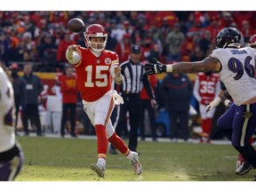 Kansas City Chiefs quarterback Patrick Mahomes (15) throws on the run past Baltimore Ravens defensive end Brent Urban (96) during the first half of an NFL football game in Kansas City, Mo., Sunday, Dec. 9, 2018.