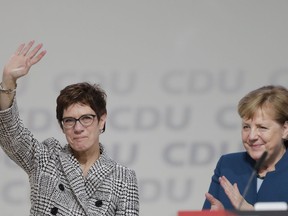 German Chancellor Angela Merkel, right, applauds newly elected party chairwoman Annegret Kramp-Karrenbauer after the election at the party convention of the Christian Democratic Democratic Union CDU in Hamburg, northern Germany, Friday, Dec. 7, 2018.