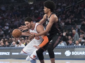 New York Knicks center Enes Kanter (00) drives against Brooklyn Nets center Jarrett Allen during the first half of an NBA basketball game, Saturday, Dec. 8, 2018, at Madison Square Garden in New York.