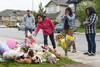 Calgarians visit a memorial outside the home of Sara Bailie and her daughter Taliyah Marsman on July 15, 2016.