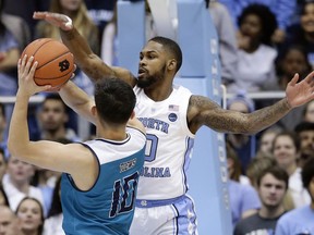 North Carolina's Seventh Woods (0) blocks UNC Wilmington's Kai Toews (10) during the first half of an NCAA college basketball game in Chapel Hill, N.C., Wednesday, Dec. 5, 2018.