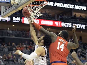 Clemson forward Elijah Thomas (14) blocks a shot by Mississippi State guard Quinndary Weatherspoon (11) during the second half of an NCAA college basketball game in the Never Forget Tribute Classic Saturday, Dec. 8, 2018, in Newark, N.J. Mississippi State won 82-71.