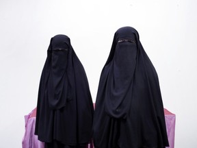 In this July 25, 2018, photo, the mother, right, and wife of of a Yemeni detainee who has been held for months in Houthi prison, pose for a photograph, in Marib, Yemen. The detainee is among thousands held without charges by Houthi militias, detained in raids targeting opponents of the Houthi rebels, who run a de facto government from Yemen's capital Sanaa.