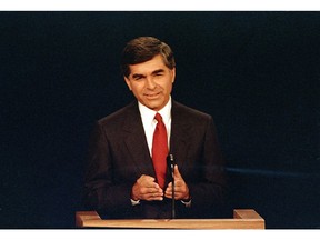 FILE - In this Sept. 25, 1988 file photo, Massachusetts Democratic Governor Michael Dukakis makes a point during the first presidential debate with his opponent U.S. Vice President George Bush in Winston-Salem, N.C. Dukakis, who lost to George H.R. Bush in the 1988 presidential election, said Saturday, Dec. 1, 2018 that his former political foe's legacy was his effort to help end the Cold War.  "Obviously we disagreed pretty strongly on domestic policy and I wasn't thrilled with the kind of campaign he ran, but I think his greatest contribution was in negotiating the end of the Cold War with (Soviet leader) Mikhail Gorbachev," Dukakis told The Associated Press in a telephone interview.