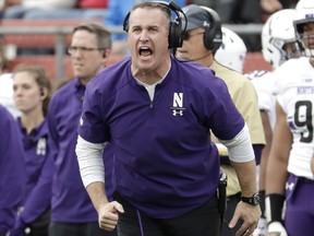 FILE - In this Saturday, Oct. 20, 2018, file photo, Northwestern head coach Pat Fitzgerald talks to his team during the first half of an NCAA college football game against Rutgers, in Piscataway, N.J. Fitzgerald was named coach of the year when The Associated Press All-Big Ten Conference team was released Wednesday, Dec. 5, 2018.