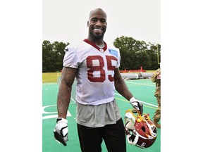 FILE - In this May 30, 2018, file photo, Washington Redskins tight end Vernon Davis (85) leaves the field following the NFL football team's full practice session at Redskins Park in Ashburn, Va. Veterans Julius Peppers, Von Miller and Vernon Davis are among the 32 nominees announced Thursday, Dec. 6, 2018, for the NFL's Walter Payton Man of the Year award.