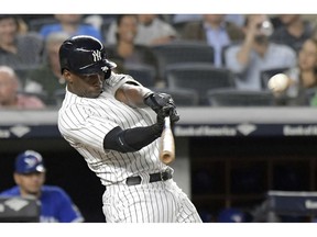 FILE - In this Sept. 14, 2018, file photo, New York Yankees' Andrew McCutchen hits a home run during the fifth inning of a baseball game against the Toronto Blue Jays, at Yankee Stadium in New York. A person familiar with the negotiations tells The Associated Press that All-Star outfielder Andrew McCutchen and the Philadelphia Phillies have agreed to a $50 million three-year contract. The person spoke on condition of anonymity Tuesday, Dec. 11, 2018, because the agreement, which includes a club option for 2022, is subject to a successful physical.