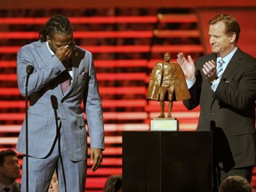 FILE - In this Feb. 1, 2014, file photo, Charles Tillman of the Chicago Bears, left, accepts the award for Walter Payton NFL Man of the Year from NFL Commissioner Roger Goodell at the third annual NFL Honors, at Radio City Music Hall in New York. Winning any of the AP's individual NFL awards, from MVP to top rookie, means plenty to players. Being nominated for, no less winning, the Walter Payton Man of the Year award, means more.