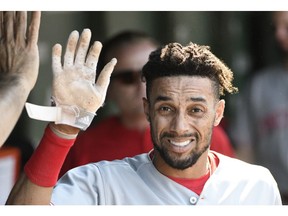 FILE - In this July 7, 2018, file photo, Cincinnati Reds' Billy Hamilton (6) is greeted in the dugout after scoring against the Chicago Cubs during the sixth inning of a baseball game, in Chicago. A person familiar with the negotiations says the Kansas City Royals and outfielder Billy Hamilton have agreed to a $5.25 million contract for next season that includes up to $1 million in incentives. The person spoke to The Associated Press on condition of anonymity Monday, Dec. 10, 2018,  because the deal was pending a physical.  The career .236 hitter's biggest attribute is his speed -- he stole at least 50 bases four straight seasons before dipping to 34 last season.