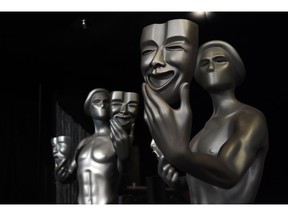 FILE - In this Jan. 27, 2017 file photo, Screen Actors Guild "Actor" statues are pictured at the Shrine Auditorium in Los Angeles.  The nominations for the 25th annual Screen Actors Guild Awards will be announced on Wednesday, Dec. 12.