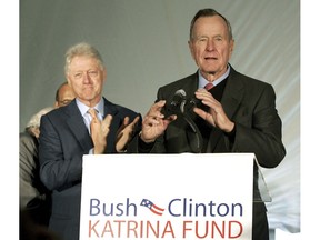 FILE - In this Dec. 7, 2005, file photo, former Presidents Bill Clinton, left, and George H.W. Bush, right, appear together during a news conference where they spoke about money they raised for Hurricane Karina victims as well as grants for higher education institutions along the Gulf Coast, at the University of New Orleans, in New Orleans. Bush teamed up with his one-time political rival, Clinton, to raise money for victims of natural disasters. It was all part of Bush's vision for what he called a "kinder, gentler nation." Bush was a humanitarian and made volunteerism a hallmark of his presidency from 1989 to 1993.