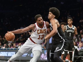 Cleveland Cavaliers center Tristan Thompson (13) pushes in on Brooklyn Nets guard Allen Crabbe (33) in the first half of an NBA basketball game, Monday, Dec. 3, 2018, in New York.