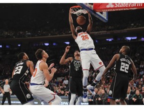 New York Knicks center Mitchell Robinson (26) dunks against the Milwaukee Bucks during the first quarter of an NBA basketball game, Saturday, Dec. 1, 2018, in New York.