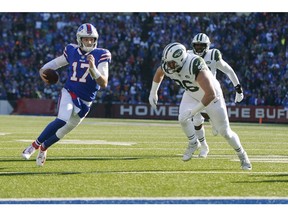 Buffalo Bills quarterback Josh Allen (17) runs past New York Jets defensive end Henry Anderson (96) for the goal line and a touchdown during the first half of an NFL football game, Sunday, Dec. 9, 2018, in Orchard Park, N.Y.