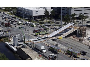 Emergency personnel respond after a brand-new pedestrian bridge collapsed onto a highway at Florida International University in Miami, crushing cars and killing several people, on March 15, 2018.