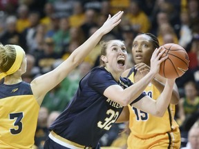 Notre Dame forward Jessica Shepard (32) drives to the basket between Toledo guard Mariella Santucci (3) and center Kaayla McIntyre (15) during the first half of an NCAA college basketball game Saturday, Dec. 8, 2018, in Toledo, Ohio.