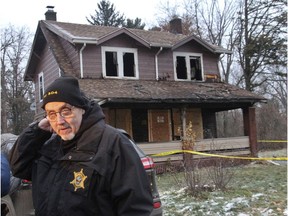 Bob Sharp with the Ohio State Fire Marshall's office stands near a home after a deadly fire in Youngstown, Ohio, Monday, Dec. 10, 2018. Authorities report that several children died in the fire.