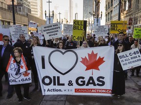 Pro-pipeline protesters gather and chant slogans outside a venue where Federal Finance Minister Bill Morneau was speaking in Calgary, Alta., Tuesday, Nov. 27, 2018.