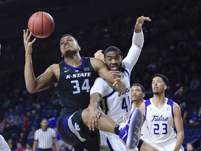 Kansas State's Levi Stockard III battles for a rebound with Tulsa's Jeriah Horne during the first half of an NCAA college basketball game in Tulsa, Okla. on Saturday, Dec. 8, 2018.