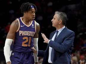 Phoenix Suns forward Richaun Holmes, left, speaks with head coach Igor Kokoskov, right, during the first half of an NBA basketball game against the Portland Trail Blazers in Portland, Ore., Thursday, Dec. 6, 2018.