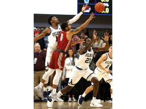 Villanova forward Saddiq Bey (15) and forward Dhamir Cosby-Roundtree (21) reach for a rebound with Saint Joseph's guard Lamarr Kimble (0) during the first half of an NCAA college basketball game, Saturday, Dec. 8, 2018, in Villanova, Pa.