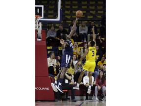 Villanova's Dhamir Cosby-Roundtree, left blocks a shot by La Salle's Jamir Moultrie during the first half of an NCAA college basketball game, Saturday, Dec. 1, 2018, in Philadelphia.