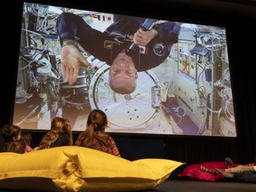 Astronaut David Saint-Jacques, aboard the International Space Station, greets a group of children gathered at the Canadian Space Agency headquarters in Longueuil , Que., on Tuesday, Dec. 18, 2018.