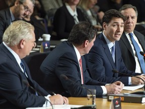 Prime Minister Justin Trudeau addresses the  first ministers meeting flanked by Ontario Premier Doug Ford, Intergovernmental Affairs Minister Dominic LeBlanc and Quebec Premier Francois Legault in Montreal.