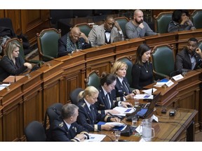 Lawyer Jacky-Eric Salvant, top right, and Gabriel Bazin, vice-president of the Ligue des Noirs du Quebec, listen to a presentation by members of the Montreal Police at City Hall in Montreal on Tuesday, December 11, 2018.