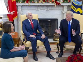 U.S. President Donald Trump, right, speaks while House Minority Leader Nancy Pelosi and U.S. Vice President Mike Pence listen during a meeting at the Oval Office of the White House in Washington, D.C., U.S., on Tuesday, Dec. 11, 2018.