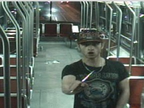 Sammy Yatim holds a knife while on a streetcar in Toronto on July 26, 2013 in this still taken from court handout surveillance video.