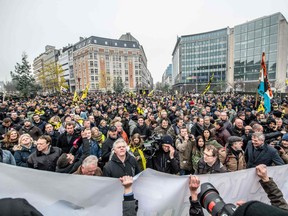 People wave the flag of the Flanders as they take part in a gathering called by the right-wing Flemish party Vlaams Belang and other organisations, in Brussels, on December 16, 2018 to protest against the UN Marrakech global pact on migration signed last week by Belgian Prime Minister.